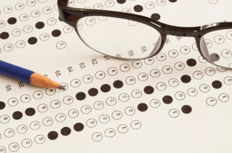 multi-choice test page with glasses and pencil